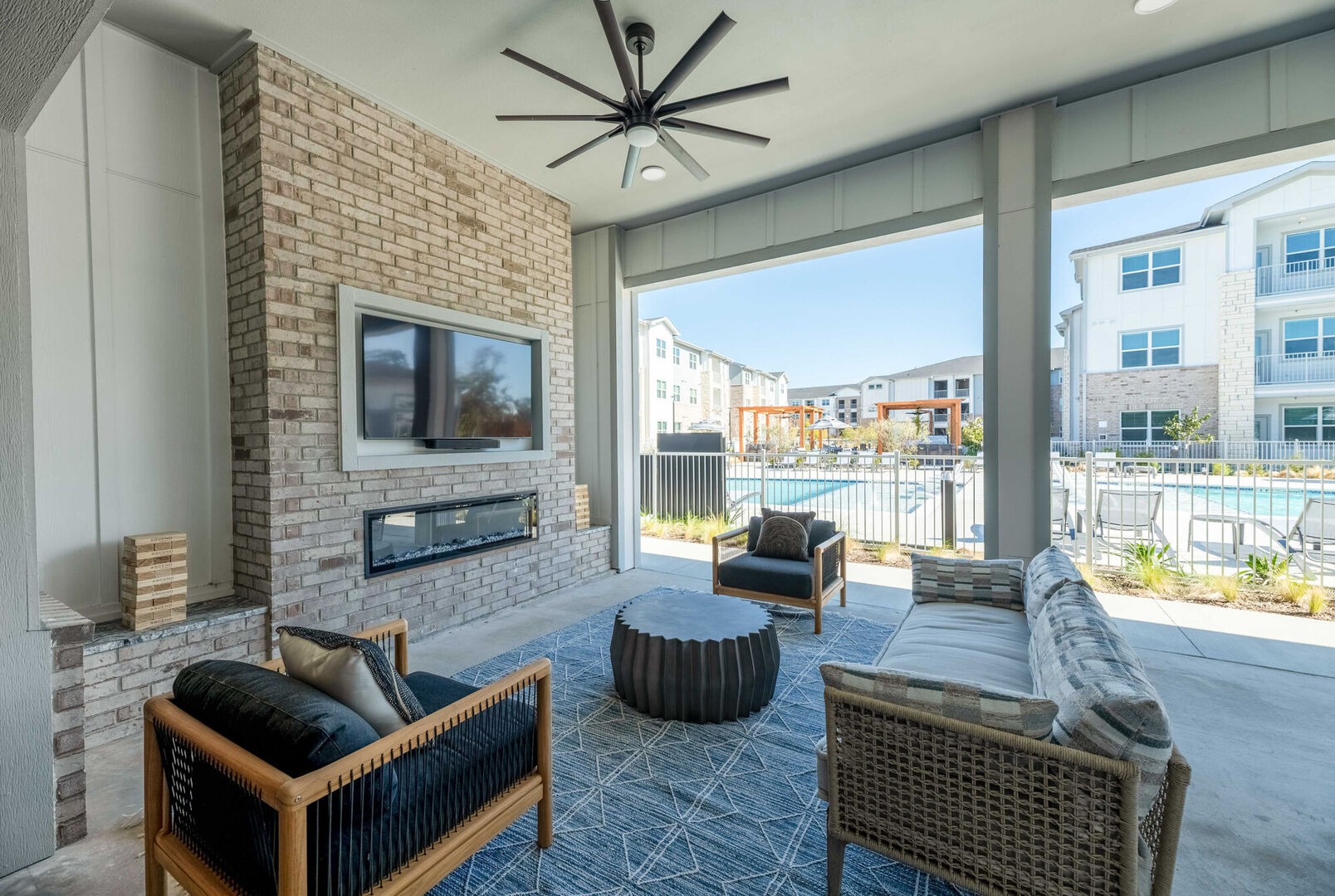 Covered outdoor lounge with fireplace