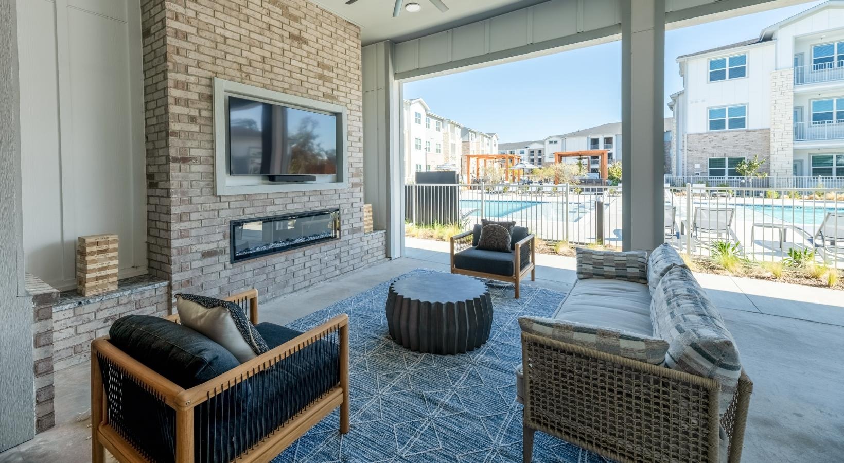 Outdoor lounge with fireplace and seating