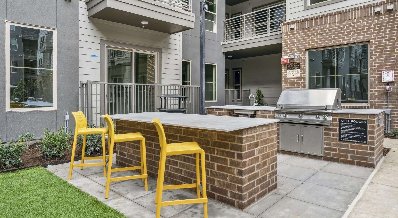 Outdoor kitchen with grills and bar seating
