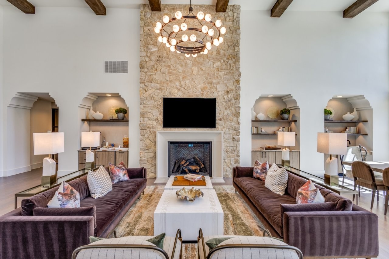 Clubhouse lounge with stone fireplace and beamed ceiling