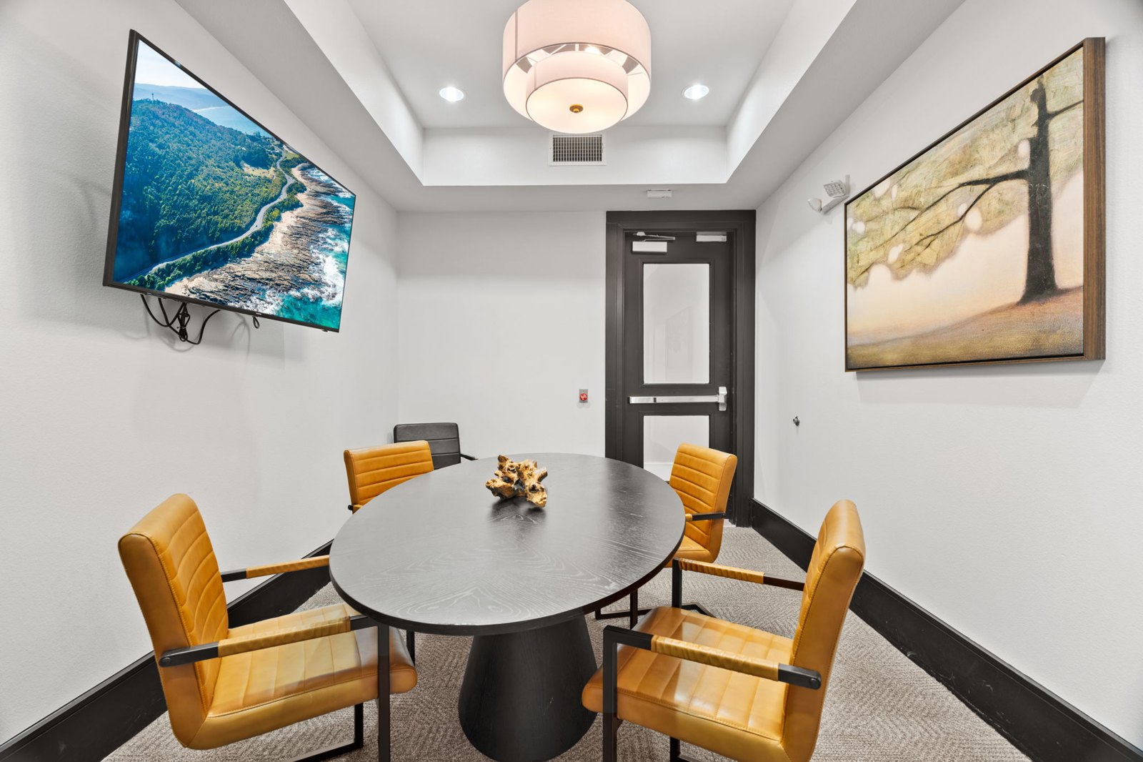 A conference room with a large table and chairs. at Axis at Watters Creek