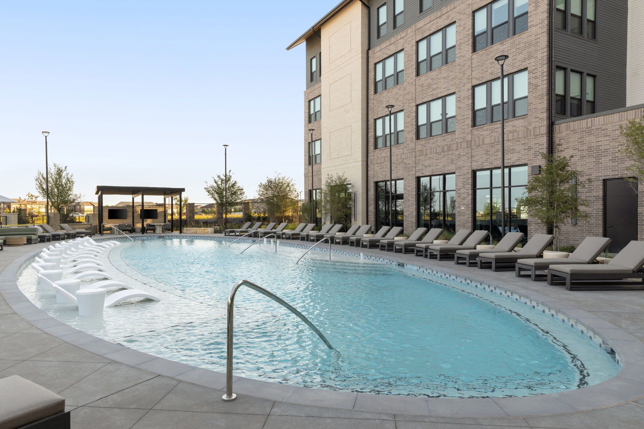 Resort-style pool with poolside loungers