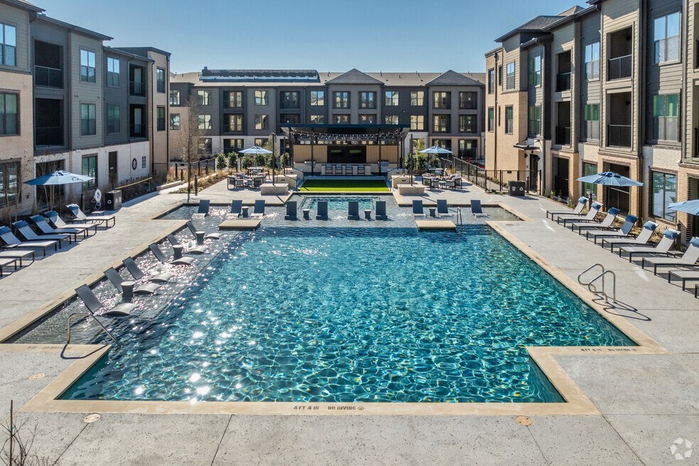 Swimming pool with sunning ledge and lounge chairs