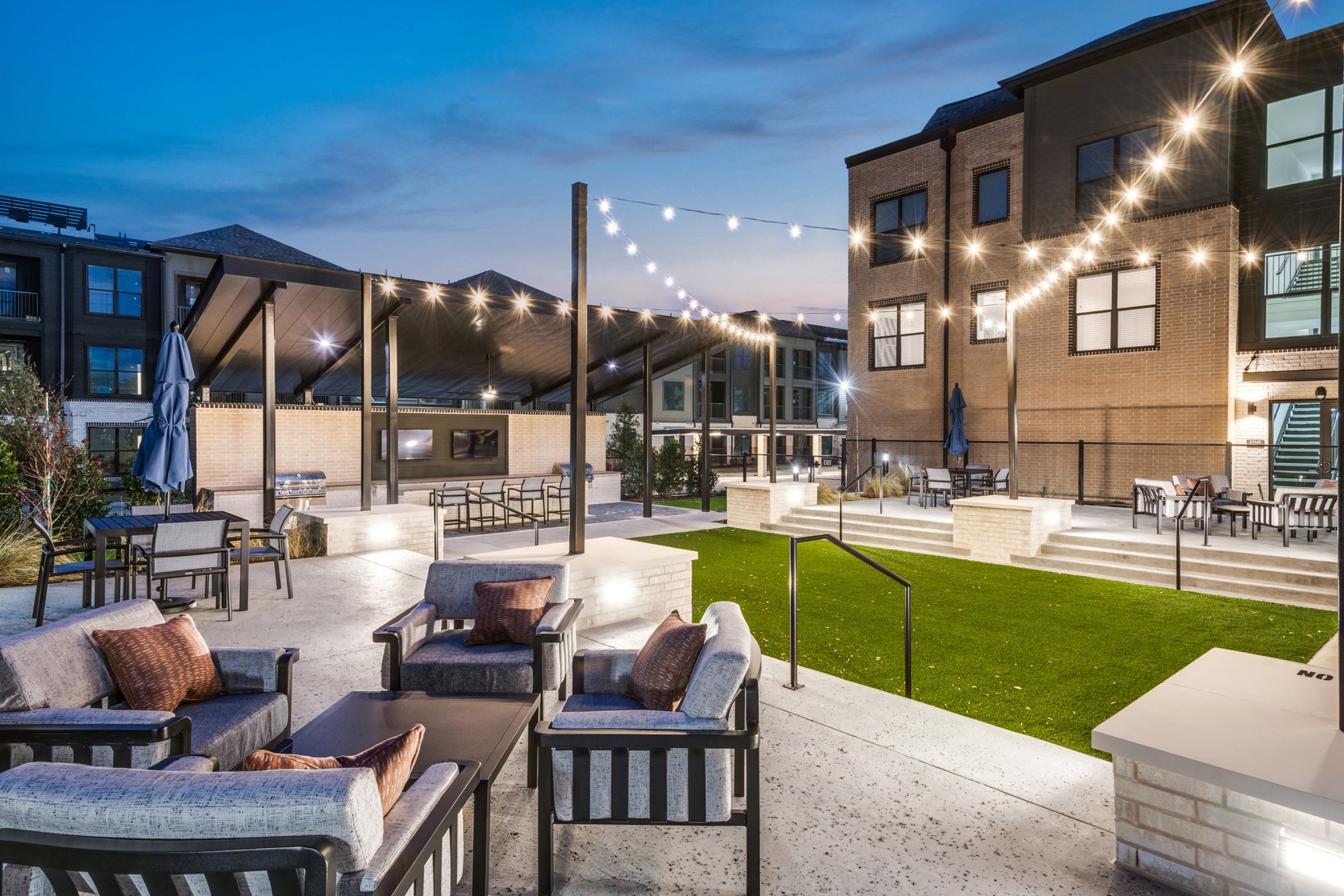 Outdoor entertainment lounge with string lights
