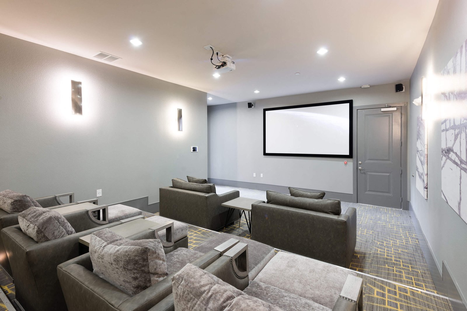 A modern home theater with a large screen and comfortable seating. at Axis at Watters Creek