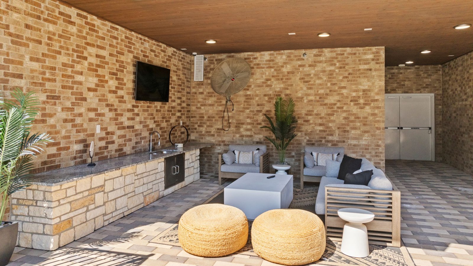 A patio with a fireplace and seating area. at Axis at Watters Creek