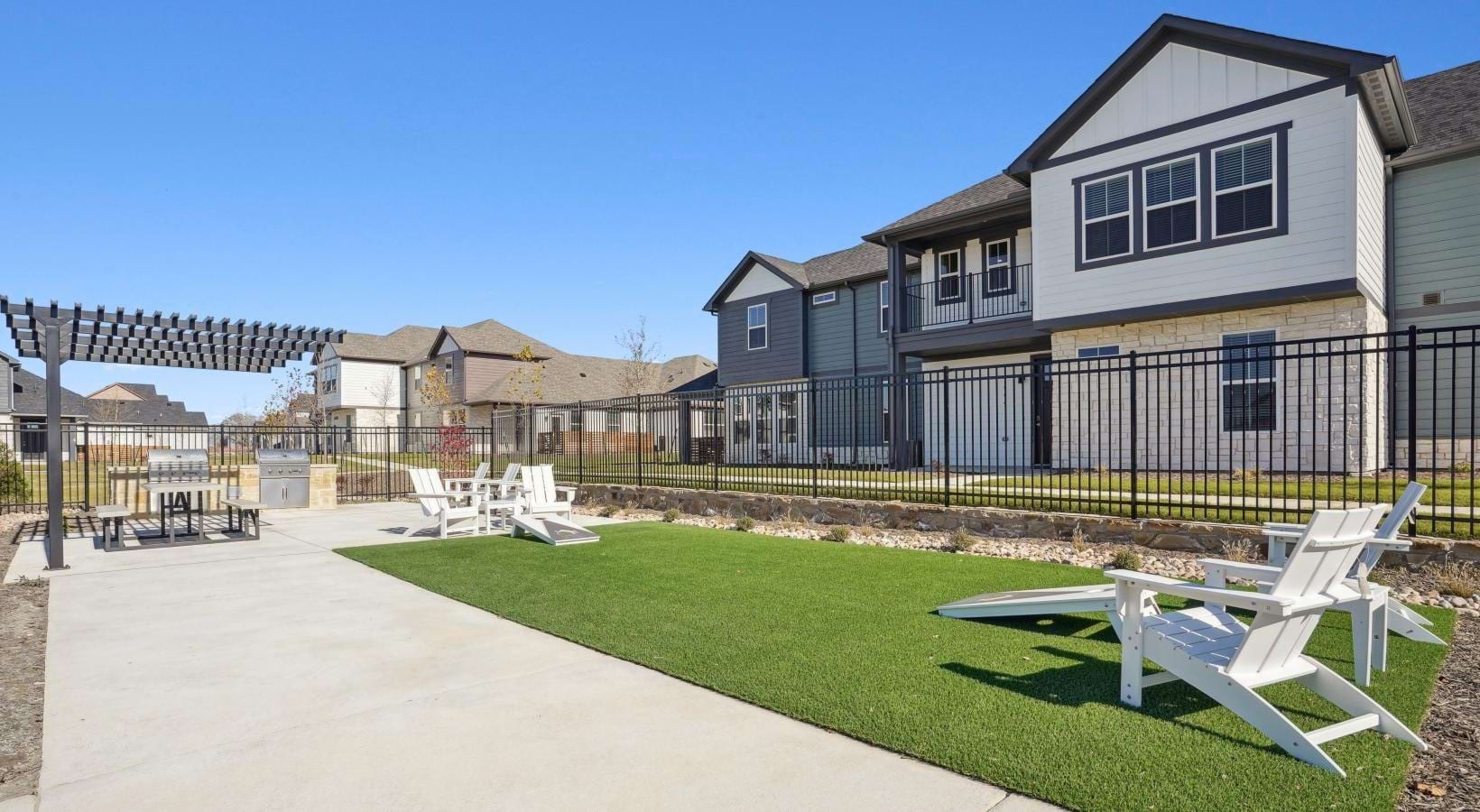 Canvas at Anna - Game lawn and patio with artificial turf and cornhole toss