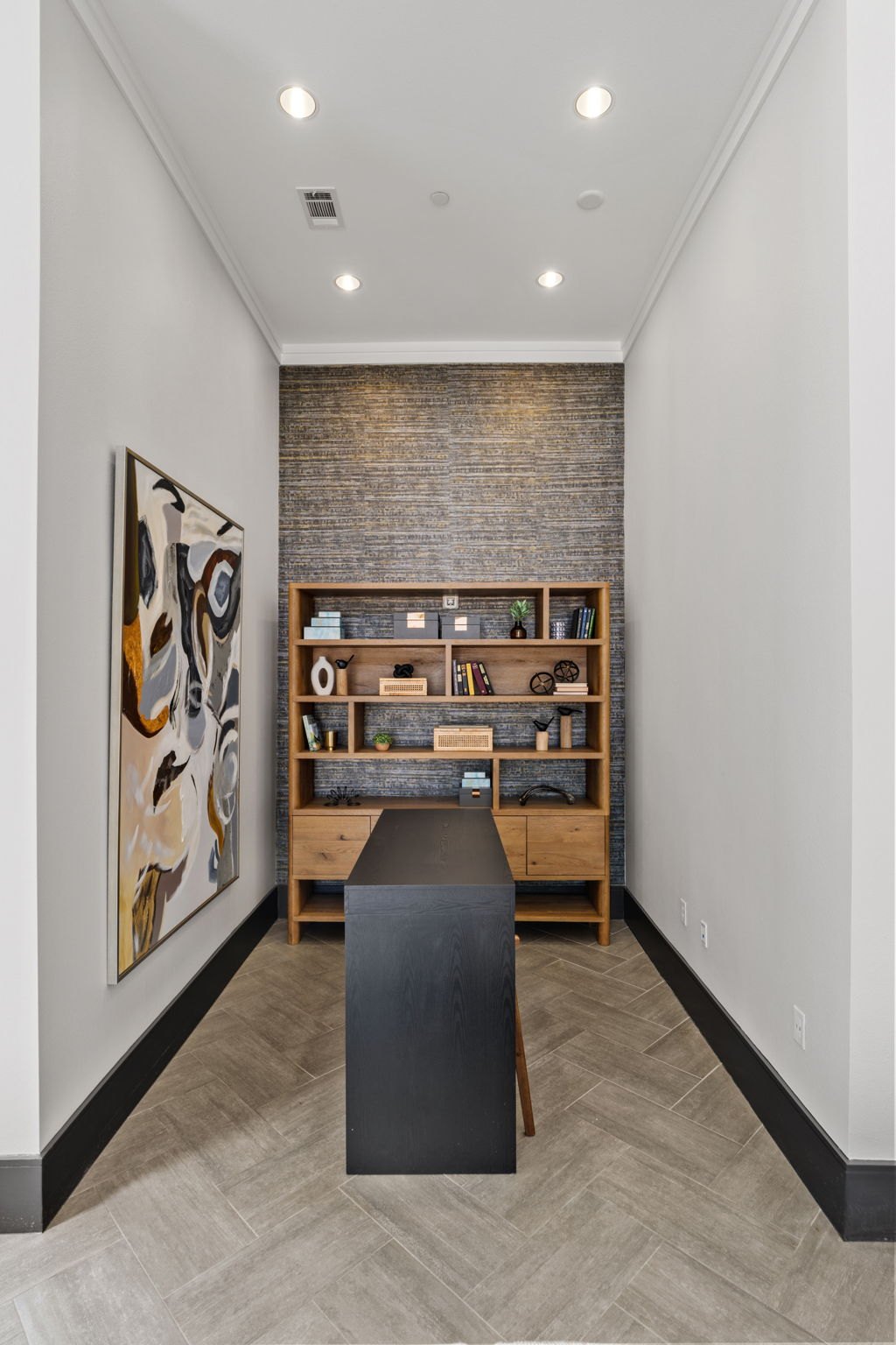 A room with a brick wall and a bookshelf. at Axis at Watters Creek