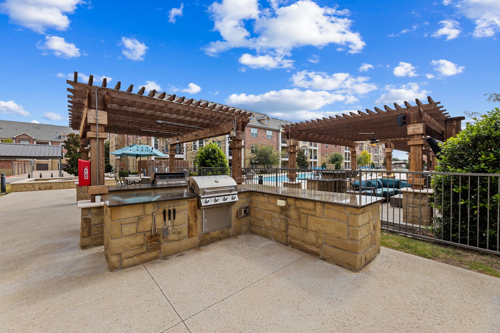 Outdoor grilling stations by the resort-style pool at Auberge of Burleson