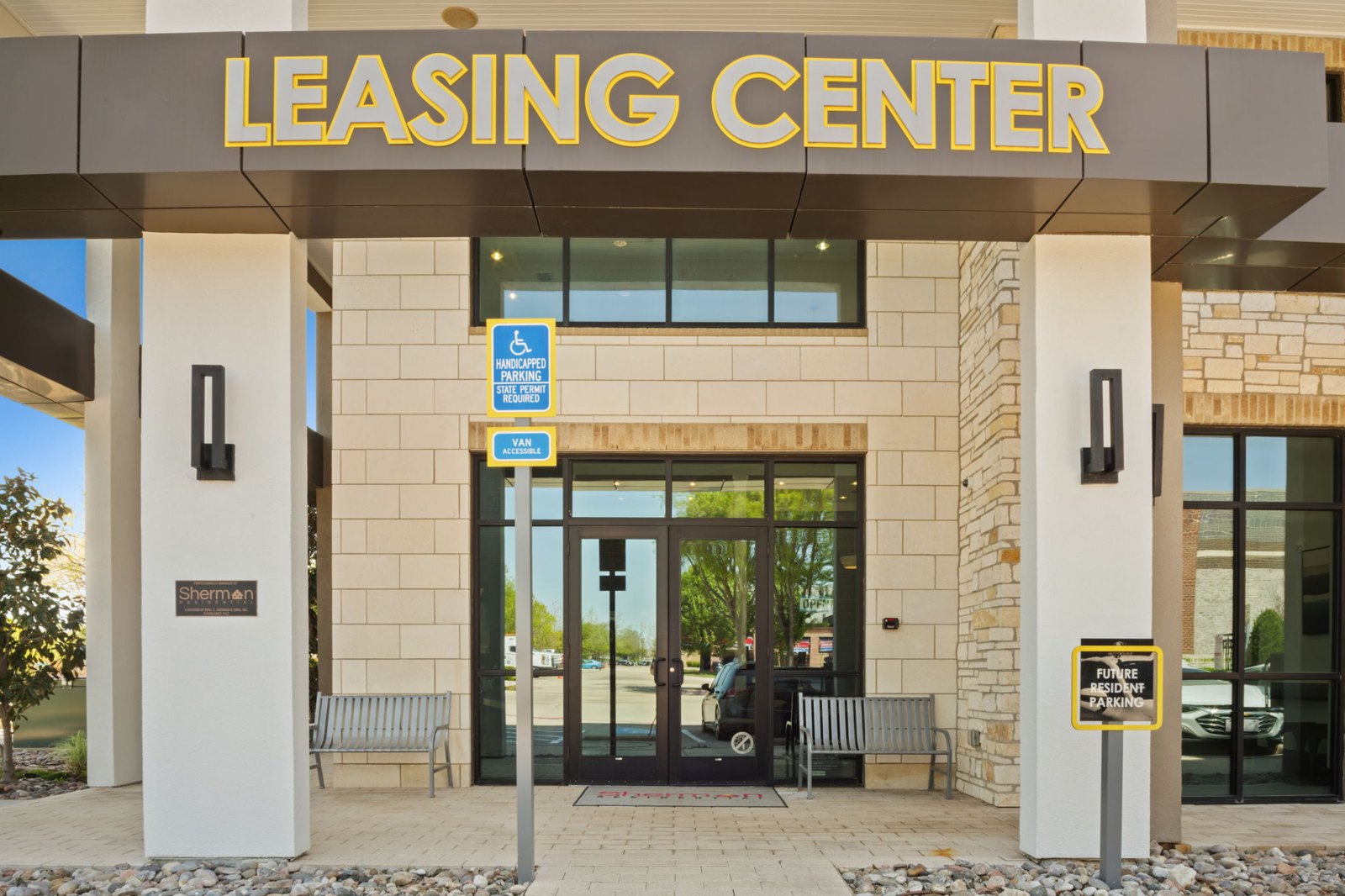 The leasing center has a parking sign on the wall. at Axis at Watters Creek