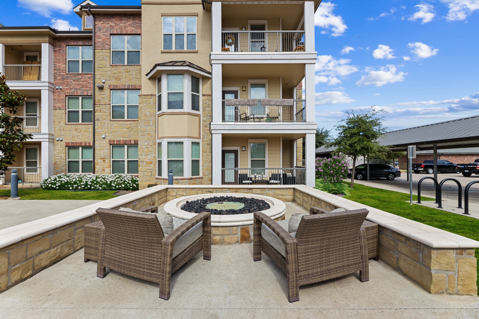 Clubhouse patio seating area and fire pit at Auberge of Burleson