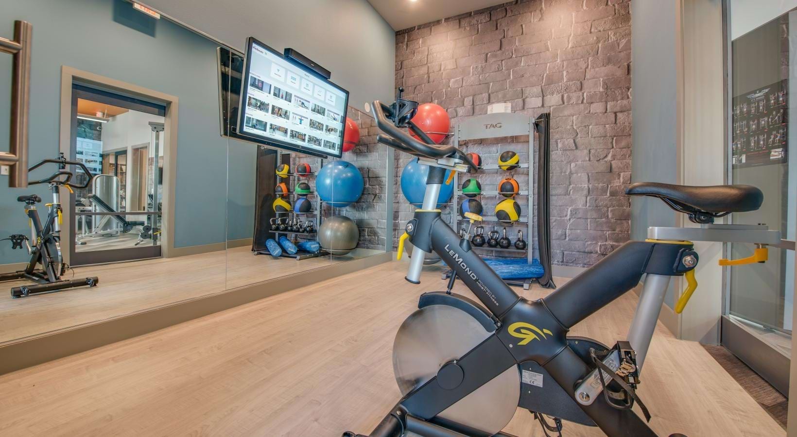 Fitness studio with spin bike and training wall at Bellrock Upper North