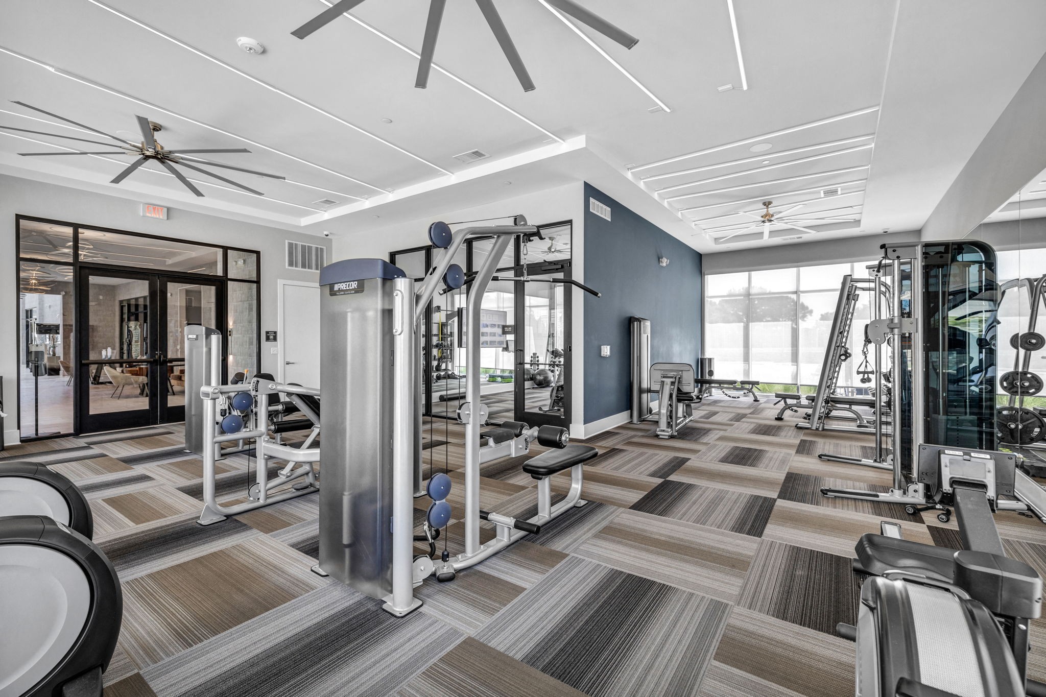 26 at City Point - A spacious gym with a variety of equipment and a ceiling fan