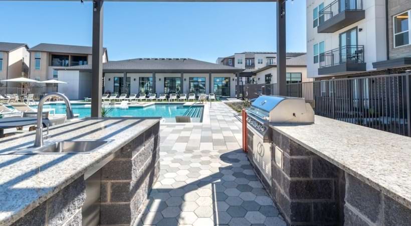 Alpine Village - Outdoor kitchen with grills overlooking the pool