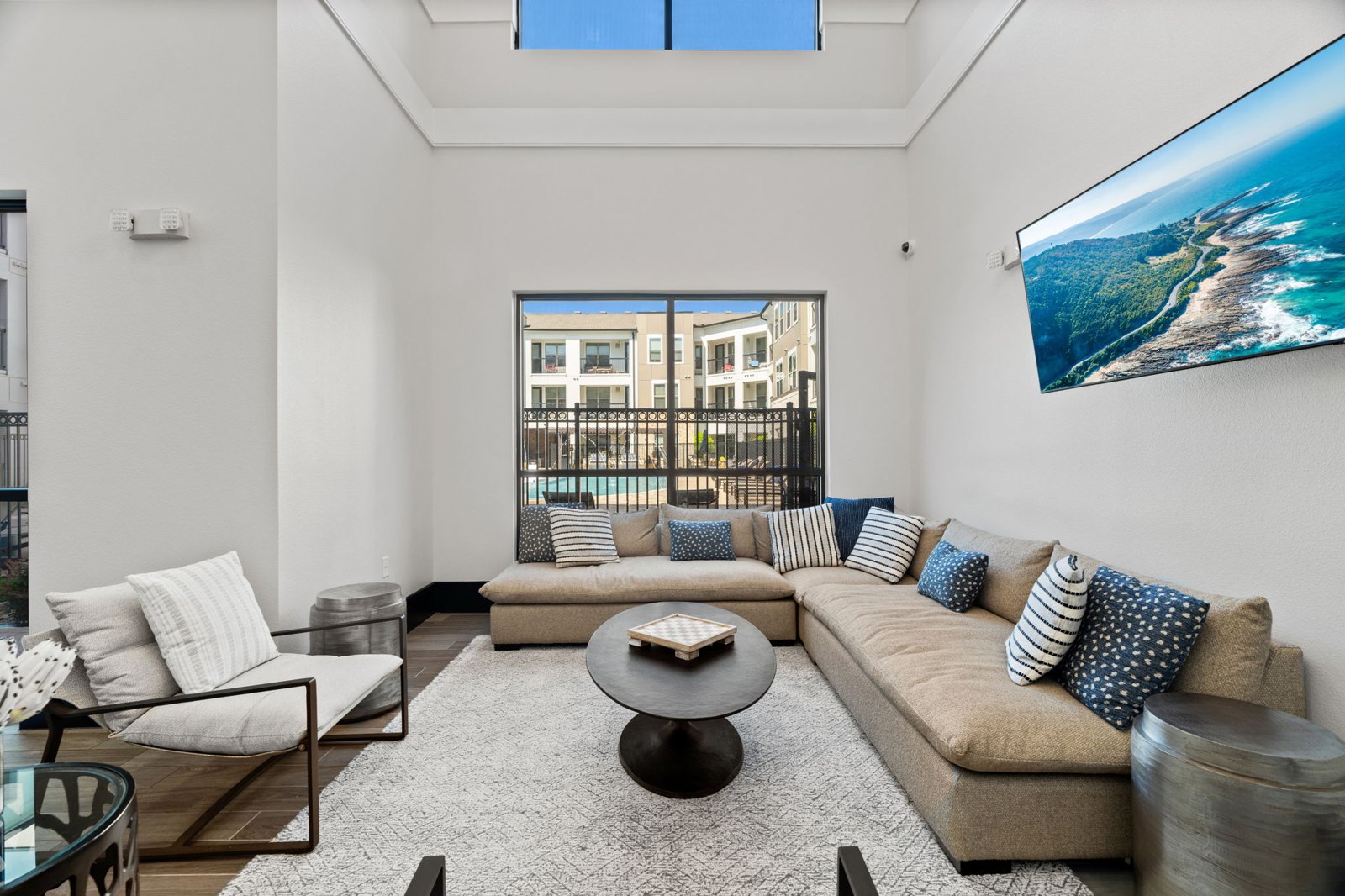 A modern living room with a large sofa and a coffee table. at Axis at Watters Creek
