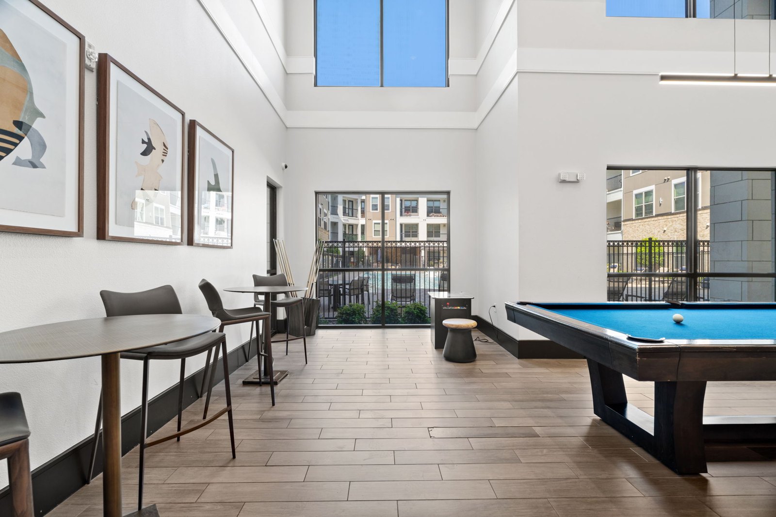 A room with a pool table and a view of the city. at Axis at Watters Creek
