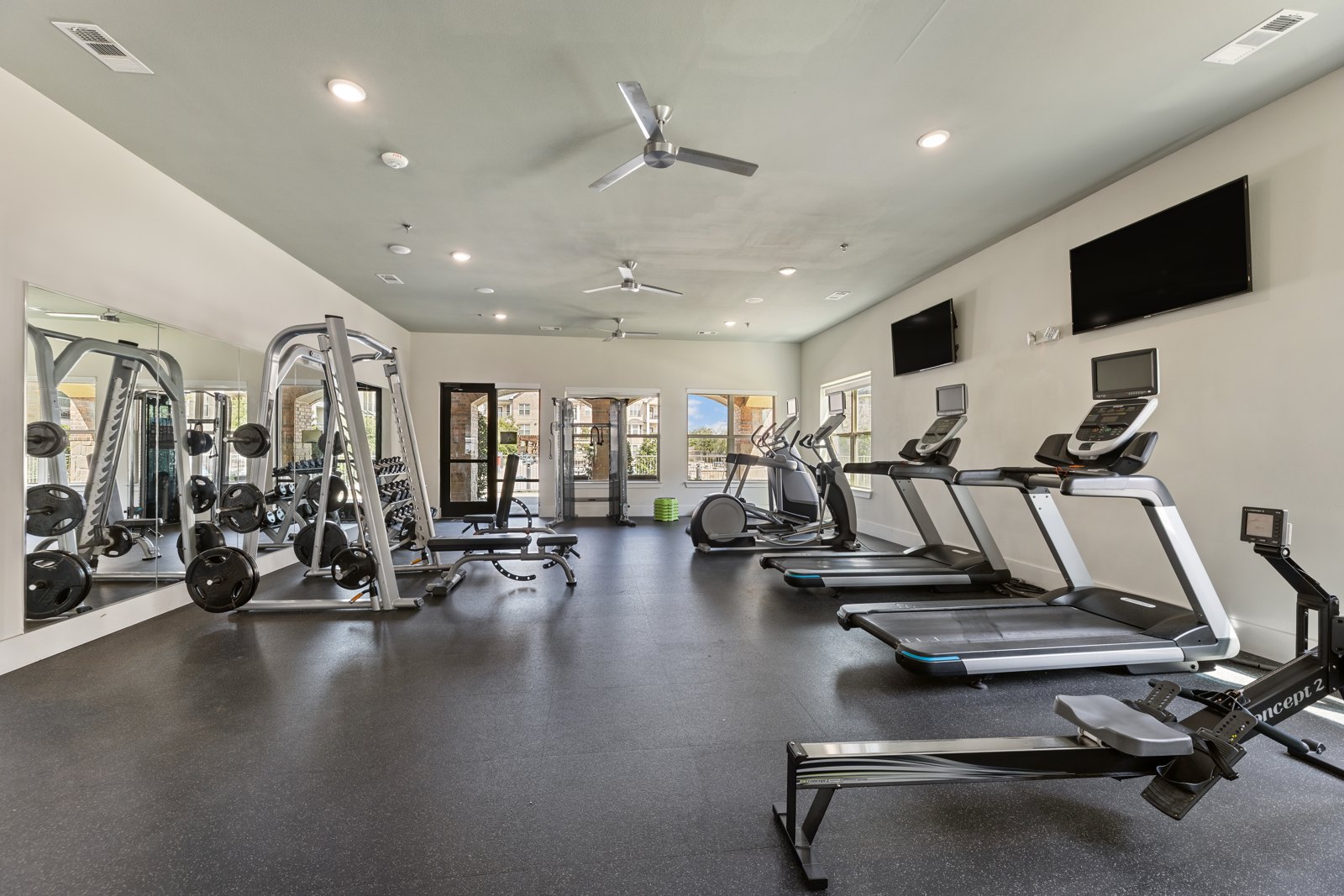 Fitness center with treadmills and ellipticals at Auberge of Burleson