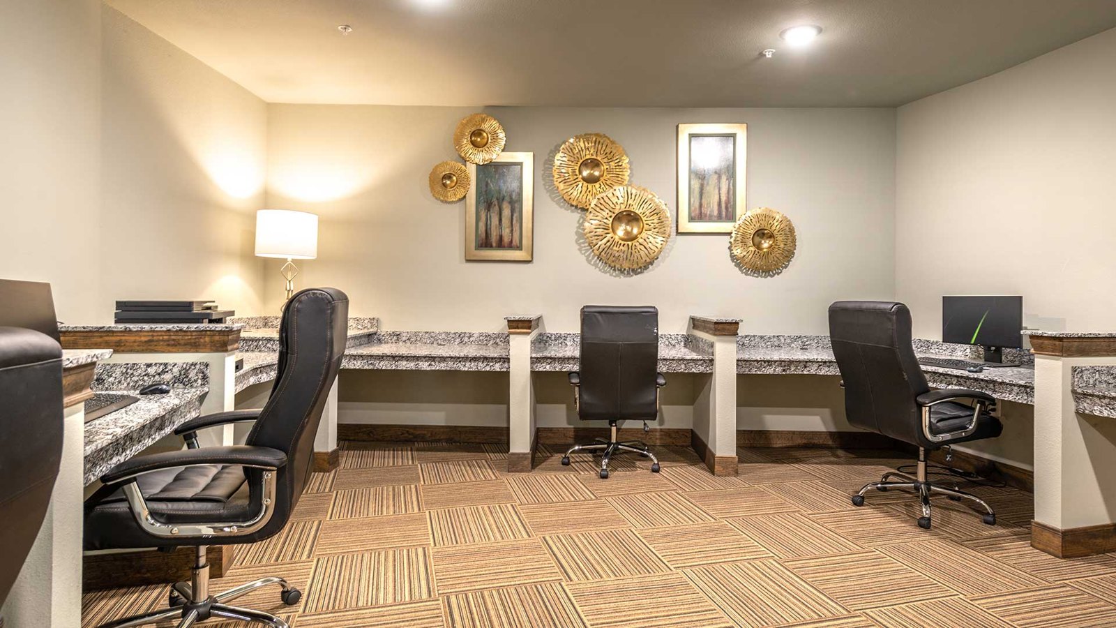 The wall is lined with several built-in desks, each with a large office chair. at Bell Tower Reserve