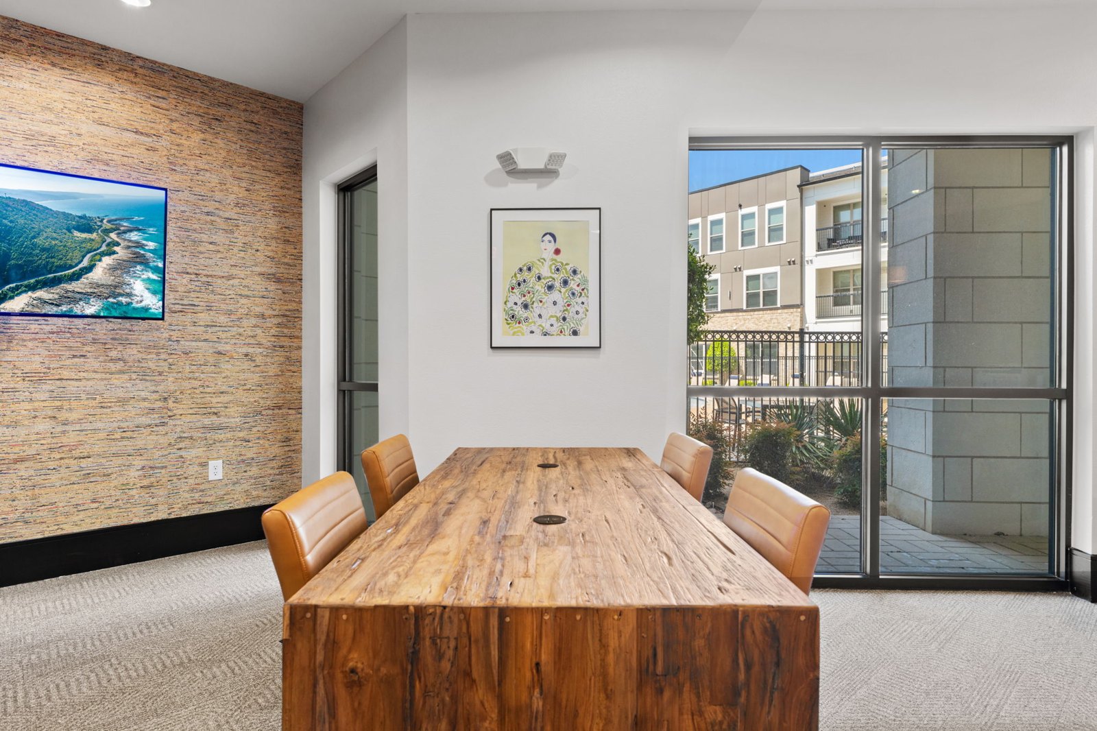 A conference room with a wooden table and chairs. at Axis at Watters Creek