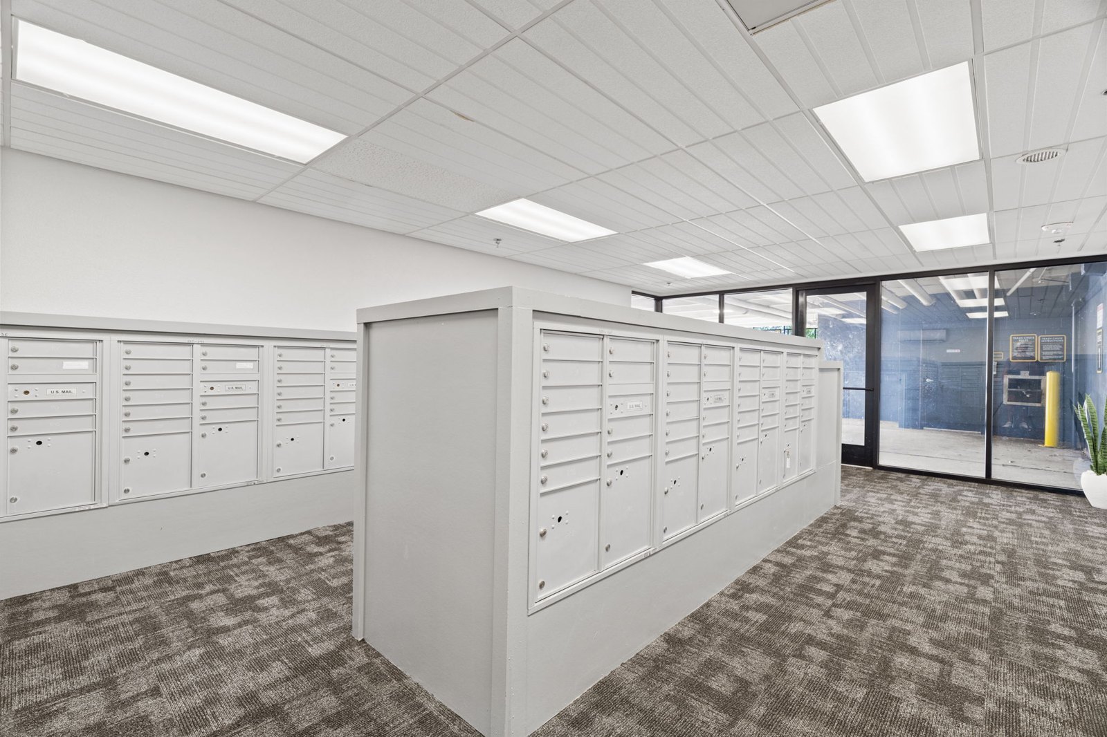 A room with white cabinets and a grey carpet. at Axis at Watters Creek