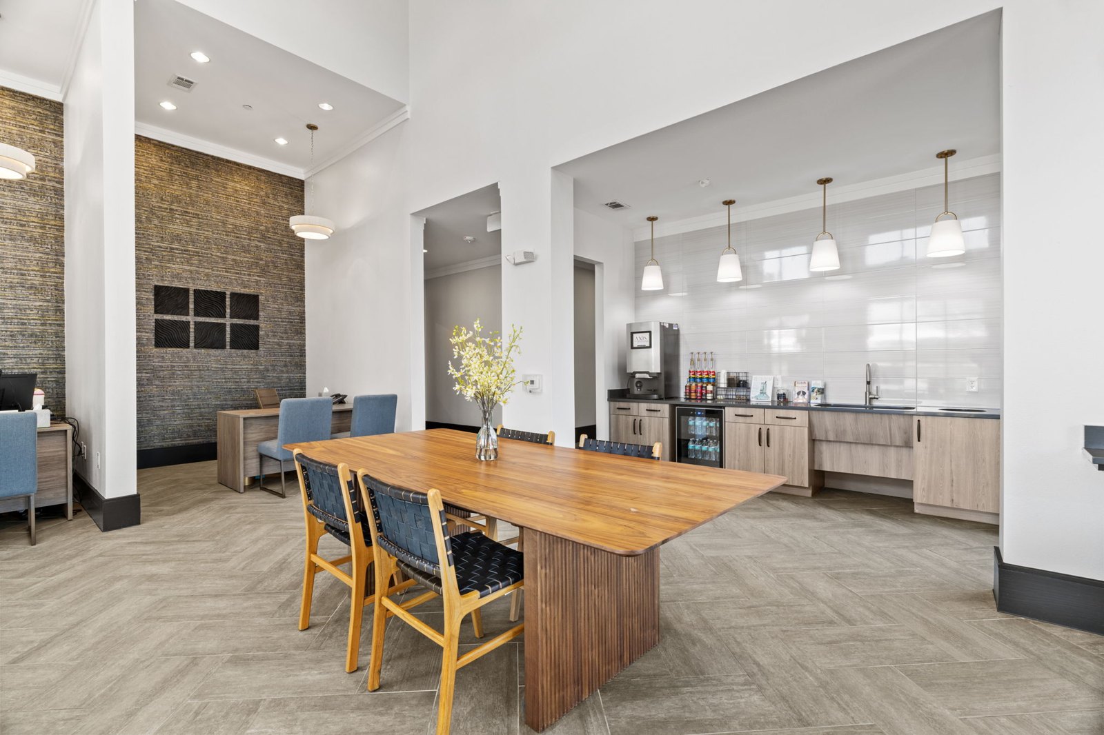 A dining room with a wooden table and chairs. at Axis at Watters Creek