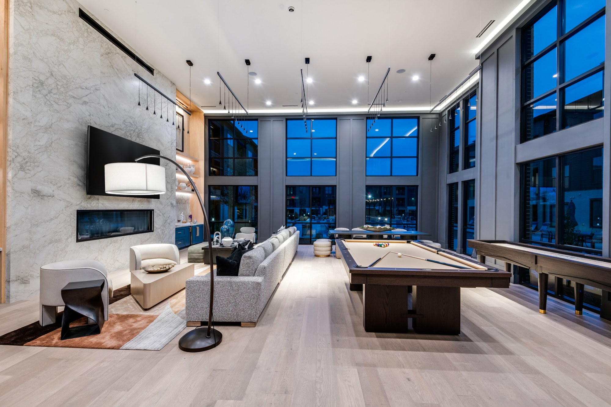 Clubhouse lounge with fireplace, billiards table and shuffleboard
