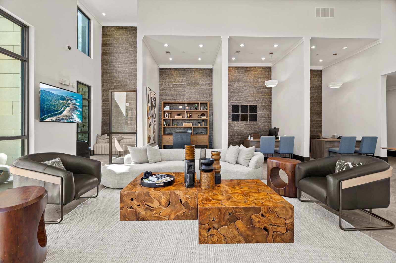 A modern living room with a wooden coffee table in the center. at Axis at Watters Creek