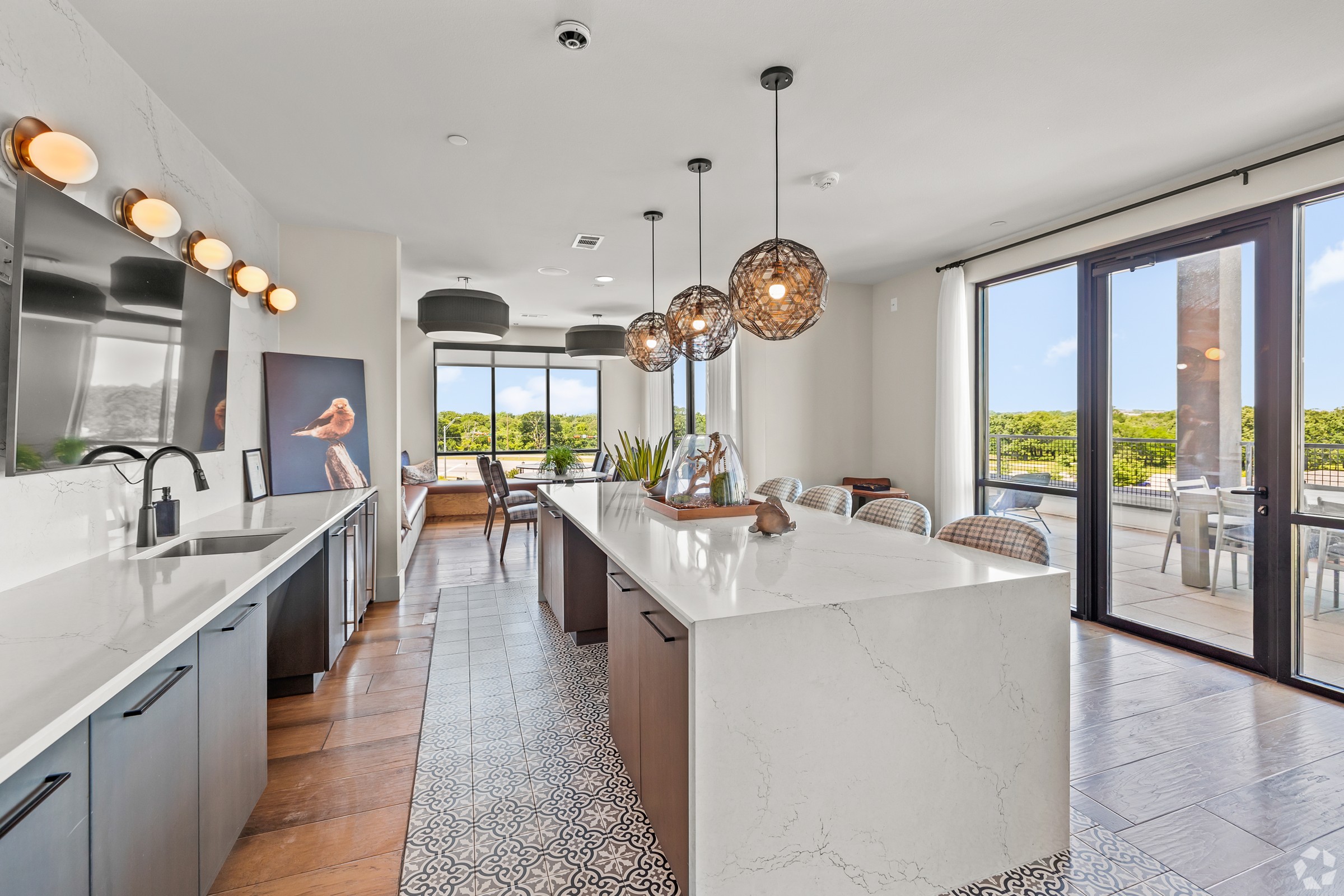 A modern kitchen with a large island and a view of the outdoors