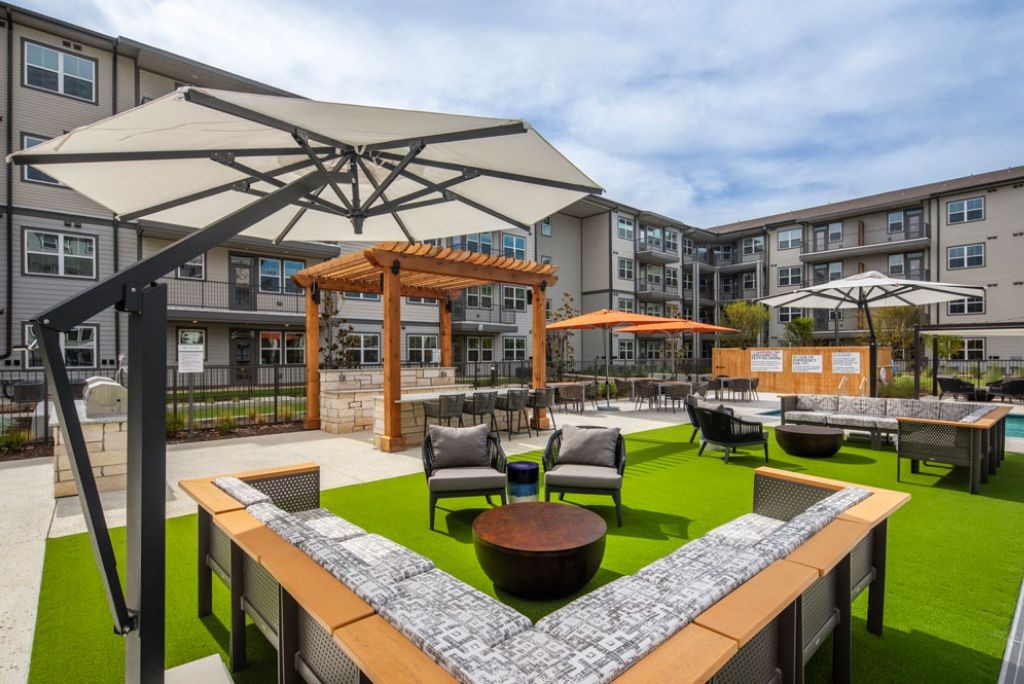 Affinity at Lewisville - Courtyard with fire pit, pergola and lounge seating