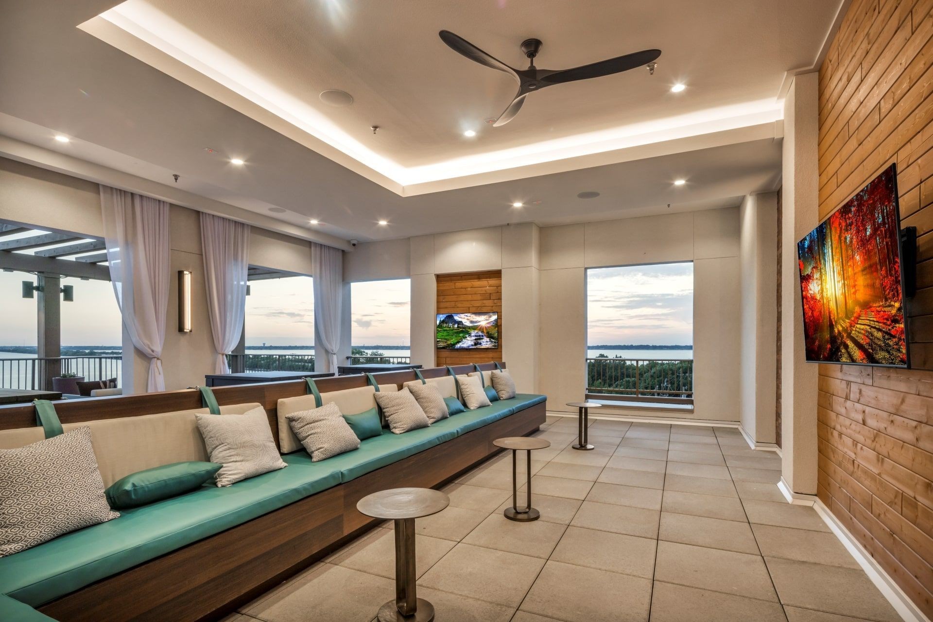 Ablon at Harbor Village - Clubhouse lounge with a long couch, tables and television