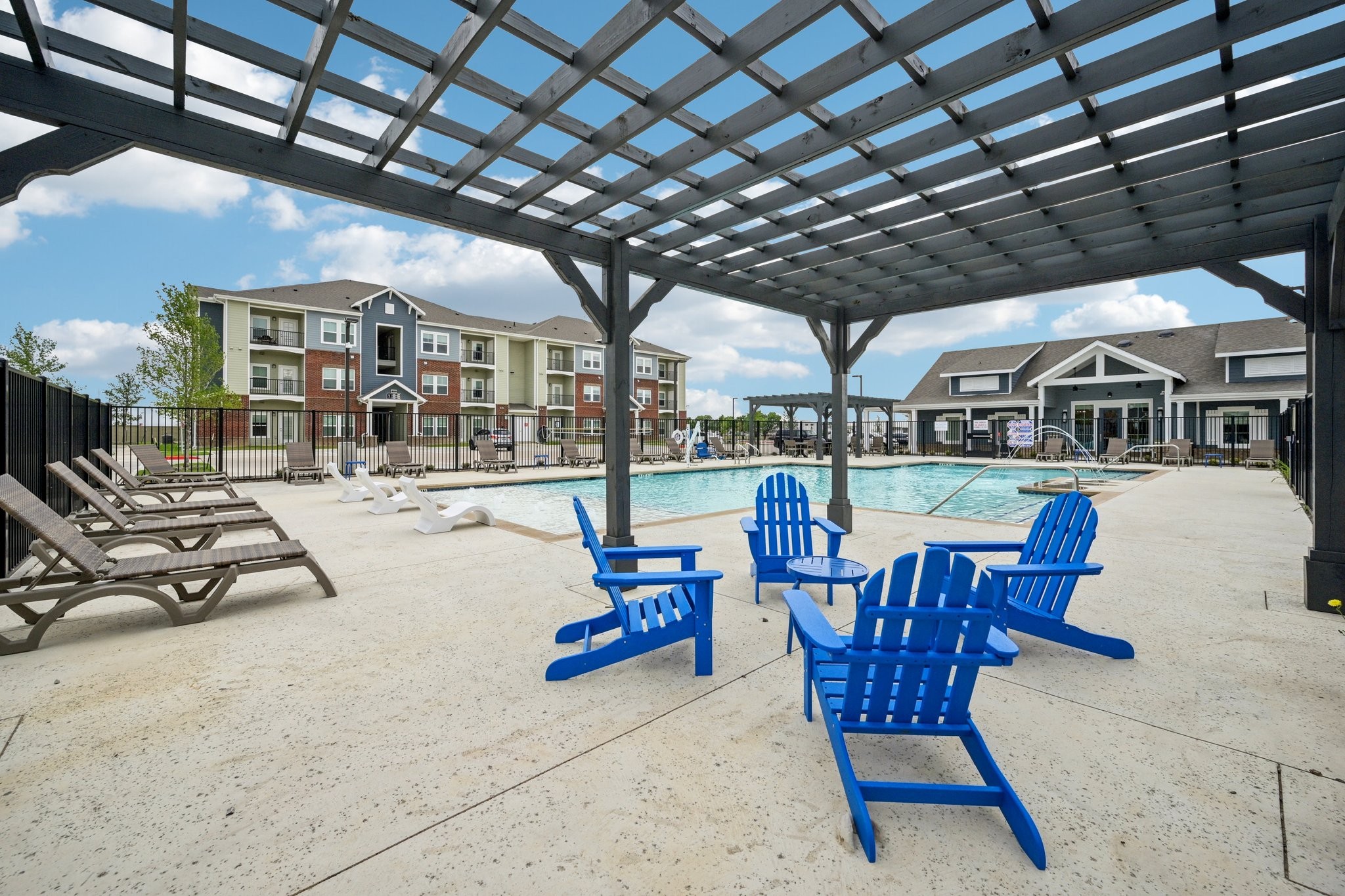 Swimming pool with pergola and lounge chairs