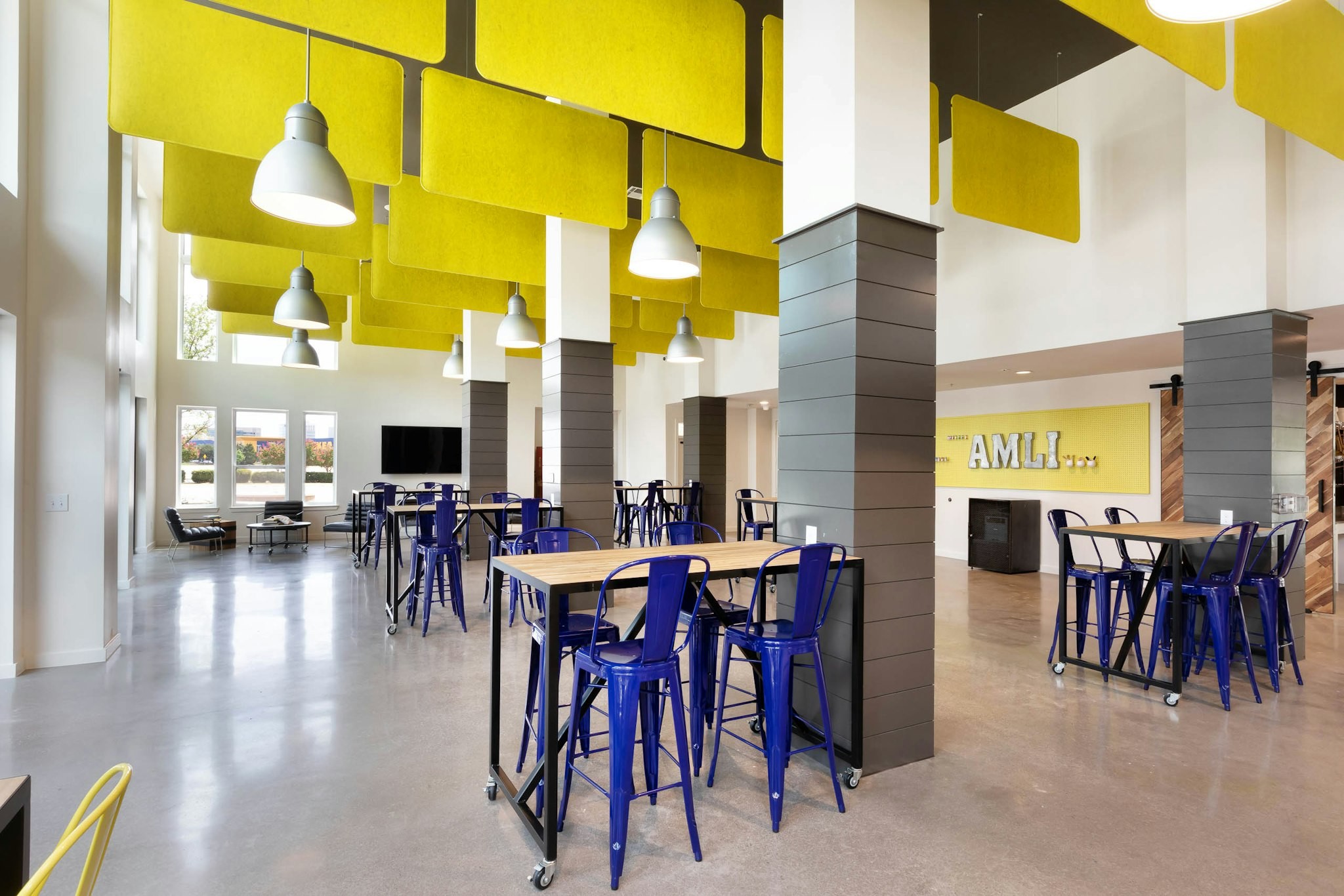AMLI Frisco Crossing - Interior of maker space with work tables for residents to gather and create at AMLI Frisco Crossing apartment building